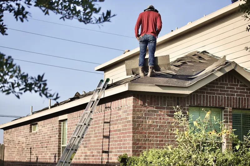 Professional roofer working on a residential roof in East Central South